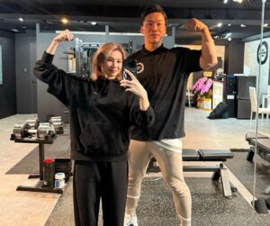 門前仲町のパーソナルジム「THE PERSONAL GYM 門前仲町店」で女性のお客様とトレーナー萩原が並んで写っている様子