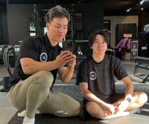 門前仲町のパーソナルジムでトレーニングのインターバル中にトレーナーと会話しながら指導を受けている様子