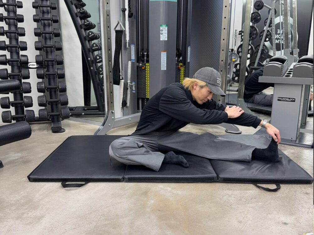 西田トレーナーがストレッチをしている写真